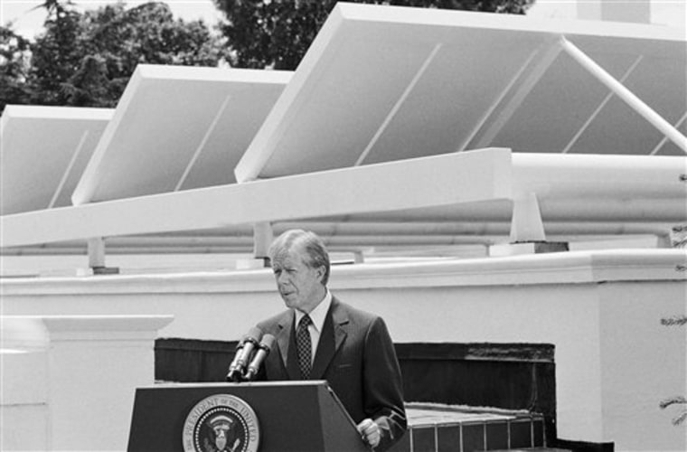 FILE - In this  June 21, 1979, file photo President Jimmy Carter speaks against a backdrop of solar panels at the White House Washington. The panels catch the suns rays and warm water used in parts of the Executive mansion.  The Obama White House will announce Tuesday, Oct. 5, 2010, that the most famous residence in America plans to install solar panels for the first time atop the White House's living quarters. The solar panels _ which will be installed by spring 2011 _ will heat water and supply some of the first family's electricity. (AP Photo/Harvey Georges, File)